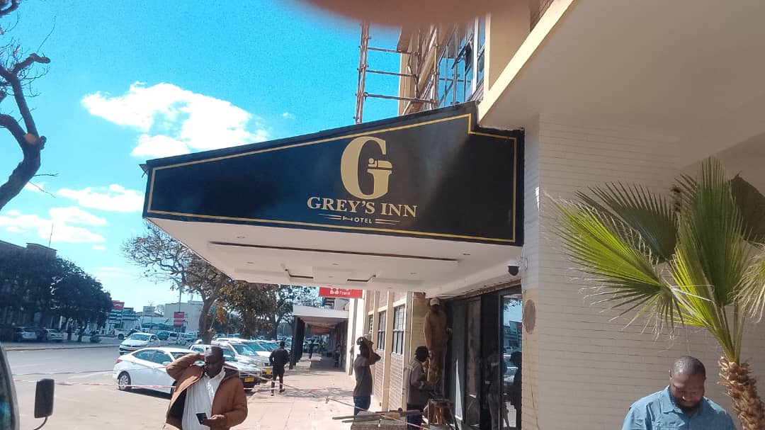 The gold Greys Inn Hotel entrance sign