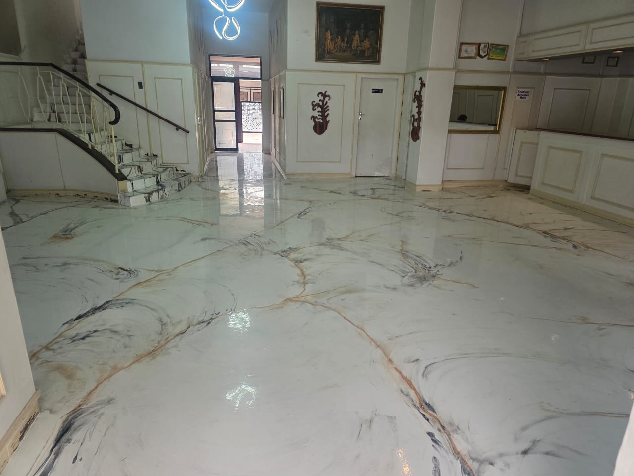 Greys Inn Hotel reception, marble-pattern flooring and curved staircase